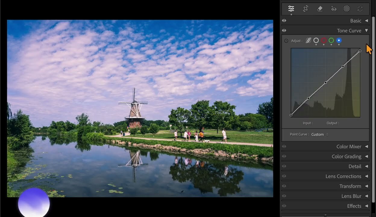 Lightroom Classic with the Tone Curve panel open beside a photo of a windmill by a lake